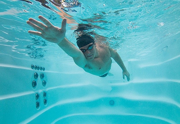 a man swimming in a swim spa a man swimming in a swim spa